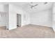This is a bedroom with neutral carpet, white walls, a ceiling fan, and an ensuite at 5505 Verbena Creek Ct, Las Vegas, NV 89131