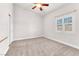 Bedroom with neutral carpet, a ceiling fan, and a window with wooden blinds at 5505 Verbena Creek Ct, Las Vegas, NV 89131