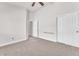 This is a bedroom with neutral carpet, white walls, a ceiling fan, and a closet at 5505 Verbena Creek Ct, Las Vegas, NV 89131