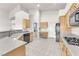 Modern kitchen with stainless appliances, light wood cabinets, and adjoining laundry at 5505 Verbena Creek Ct, Las Vegas, NV 89131