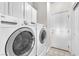 Bright laundry room with modern washer and dryer, tile floor, and ample space at 5505 Verbena Creek Ct, Las Vegas, NV 89131