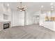 Open-concept living space featuring a fireplace, carpet, and plenty of natural light at 5505 Verbena Creek Ct, Las Vegas, NV 89131
