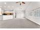 Spacious living room featuring an open floor plan, neutral carpet, and bright natural light at 5505 Verbena Creek Ct, Las Vegas, NV 89131