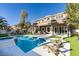 Backyard featuring a sparkling pool, jacuzzi, covered patio with furniture, and landscaping at 5573 San Florentine Ave, Las Vegas, NV 89141