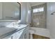 Bathroom featuring a large mirror, granite counters, and a bath tub with a shower at 5573 San Florentine Ave, Las Vegas, NV 89141