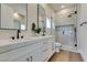 Modern bathroom features a double vanity with black fixtures, gold accents, and a frameless glass shower at 5573 San Florentine Ave, Las Vegas, NV 89141