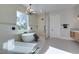 Bright bathroom featuring a soaking tub, glass shower, window, and a modern chandelier at 5573 San Florentine Ave, Las Vegas, NV 89141