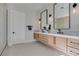 Sleek bathroom features double sinks, floating vanity, modern lighting, and a glass shower enclosure at 5573 San Florentine Ave, Las Vegas, NV 89141