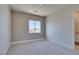 A bright bedroom has a window view, neutral paint and carpet at 5573 San Florentine Ave, Las Vegas, NV 89141