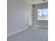 A sparsely furnished bedroom, painted in neutral tones with a window and carpet at 5573 San Florentine Ave, Las Vegas, NV 89141