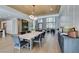 Open-concept dining room with wood-look ceiling, and open view to living room and kitchen at 5573 San Florentine Ave, Las Vegas, NV 89141