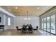 Dining room with wood-look ceiling, modern lighting, paneled accent wall and backyard access at 5573 San Florentine Ave, Las Vegas, NV 89141