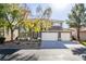 Charming two-story home featuring a well-maintained lawn, mature trees, and a three-car garage at 5573 San Florentine Ave, Las Vegas, NV 89141