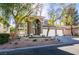 Elegant home with manicured landscaping, modern front door, and a three-car garage at 5573 San Florentine Ave, Las Vegas, NV 89141