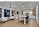Well-lit kitchen features an island, modern cabinetry, stainless steel appliances, and a cozy seating area at 5573 San Florentine Ave, Las Vegas, NV 89141