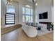 Open-concept living room featuring large windows, fireplace, and modern furnishings at 5573 San Florentine Ave, Las Vegas, NV 89141