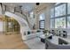 Bright living room features soaring ceilings, staircase, and expansive windows offering abundant natural light at 5573 San Florentine Ave, Las Vegas, NV 89141