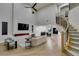 Spacious living area with fireplace, curved staircase, and open floor plan at 5573 San Florentine Ave, Las Vegas, NV 89141