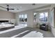 Spacious bedroom boasts sliding glass doors to a balcony, seating area, and sleek ceiling fan at 5573 San Florentine Ave, Las Vegas, NV 89141
