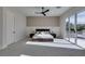 The bedroom has a sliding glass door to a balcony and a modern ceiling fan at 5573 San Florentine Ave, Las Vegas, NV 89141