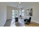Bright home office with desk, chair, modern art, and sliding glass doors to outdoor patio at 5573 San Florentine Ave, Las Vegas, NV 89141