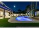 Stunning backyard oasis with pool, patio and lush landscaping, perfect for evening enjoyment at 5573 San Florentine Ave, Las Vegas, NV 89141