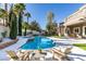Backyard featuring a sparkling pool, jacuzzi, landscaping, and lounge chairs at 5573 San Florentine Ave, Las Vegas, NV 89141