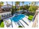 Backyard featuring a sparkling pool, jacuzzi, landscaping, and lounge chairs at 5573 San Florentine Ave, Las Vegas, NV 89141