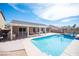 The backyard shows a pool next to a covered patio with an outdoor kitchen at 5600 Old Stable Ave, Las Vegas, NV 89131