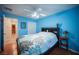 Blue bedroom with wood floors, a ceiling fan, and a white closet door at 5600 Old Stable Ave, Las Vegas, NV 89131