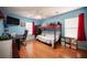 Comfortable blue bedroom featuring bunkbeds, desk, and wood laminate flooring at 5600 Old Stable Ave, Las Vegas, NV 89131