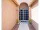 A close-up view of the home's entry with black screen doors and sunflowers at 5600 Old Stable Ave, Las Vegas, NV 89131