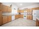 Bright kitchen features white appliances, tile floors, and light wood cabinetry at 5600 Old Stable Ave, Las Vegas, NV 89131