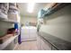 Functional laundry room with appliances, storage shelves, and countertop space at 5600 Old Stable Ave, Las Vegas, NV 89131