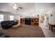 Spacious living room with a fireplace, media center and view into the kitchen at 5600 Old Stable Ave, Las Vegas, NV 89131