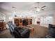 Spacious living room with a fireplace, media center and view of the front door at 5600 Old Stable Ave, Las Vegas, NV 89131