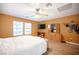 Bright bedroom boasts wood floors, a ceiling fan, neutral walls, and natural light at 5600 Old Stable Ave, Las Vegas, NV 89131
