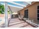 Covered patio with seating area and built-in grill overlooking the backyard at 5600 Old Stable Ave, Las Vegas, NV 89131