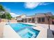 Backyard with a pool, spa, and covered patio, creating an ideal outdoor living space for entertaining and relaxing at 5600 Old Stable Ave, Las Vegas, NV 89131