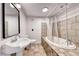 Classic bathroom with tiled flooring, pedestal sink, and a tiled shower-tub combination at 6 Montana Way, Henderson, NV 89015