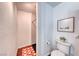 Bright bathroom featuring white tiled shower, toilet, and decorative picture at 6 Montana Way, Henderson, NV 89015