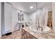 Charming bathroom featuring a pedestal sink and tiled tub and shower at 6 Montana Way, Henderson, NV 89015