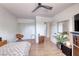 Bright bedroom with hardwood floors, a large window, and a comfortable bed and tv at 6 Montana Way, Henderson, NV 89015