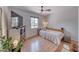 Cozy bedroom with neutral walls, wood floors, and a stylish accent wall with a mounted tv at 6 Montana Way, Henderson, NV 89015