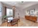 Sunlit dining room with light wood floors, stylish furniture, and a welcoming atmosphere at 6 Montana Way, Henderson, NV 89015