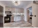 Modern kitchen with stainless appliances, bright cabinets, and adjacent dining area offers an easy flow for meal preparation at 6 Montana Way, Henderson, NV 89015
