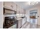 Updated kitchen with stainless steel appliances, light cabinets, and wood floors offers a modern and functional cooking space at 6 Montana Way, Henderson, NV 89015
