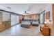 Cozy living room with wood paneling, natural light, and a large sectional provides a comfortable and inviting space at 6 Montana Way, Henderson, NV 89015