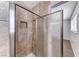 Tiled shower with a glass door, a shower niche, and modern hardware in the bathroom at 6204 Parsifal Pl, Las Vegas, NV 89107