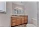 Bathroom featuring a vanity with drawers, an oversized mirror, and modern vanity lighting at 6204 Parsifal Pl, Las Vegas, NV 89107